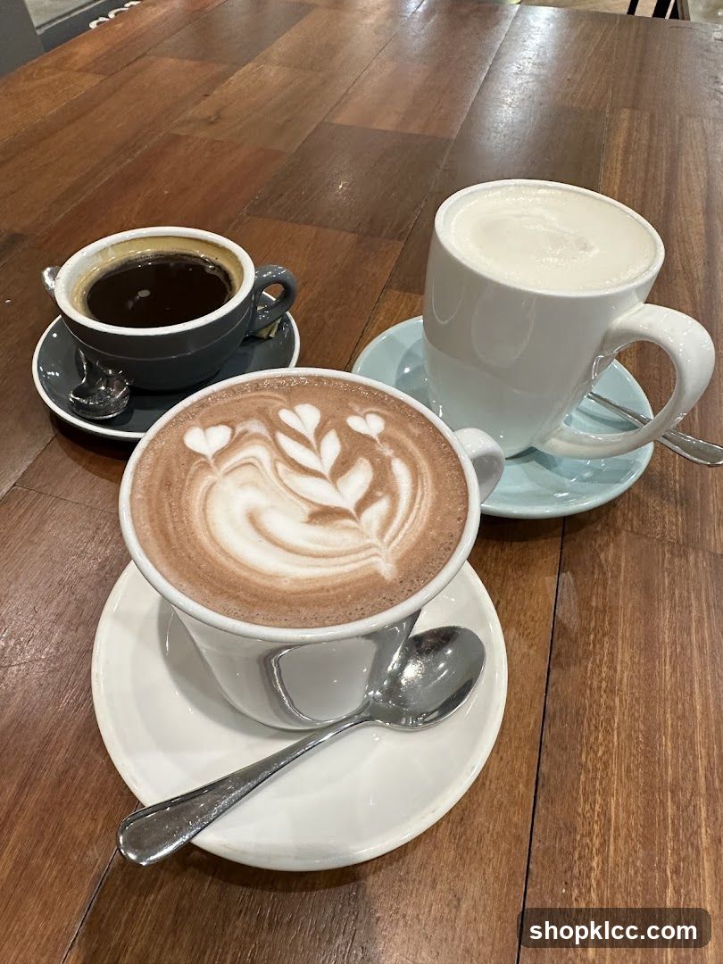 Three coffee drinks on a wooden table