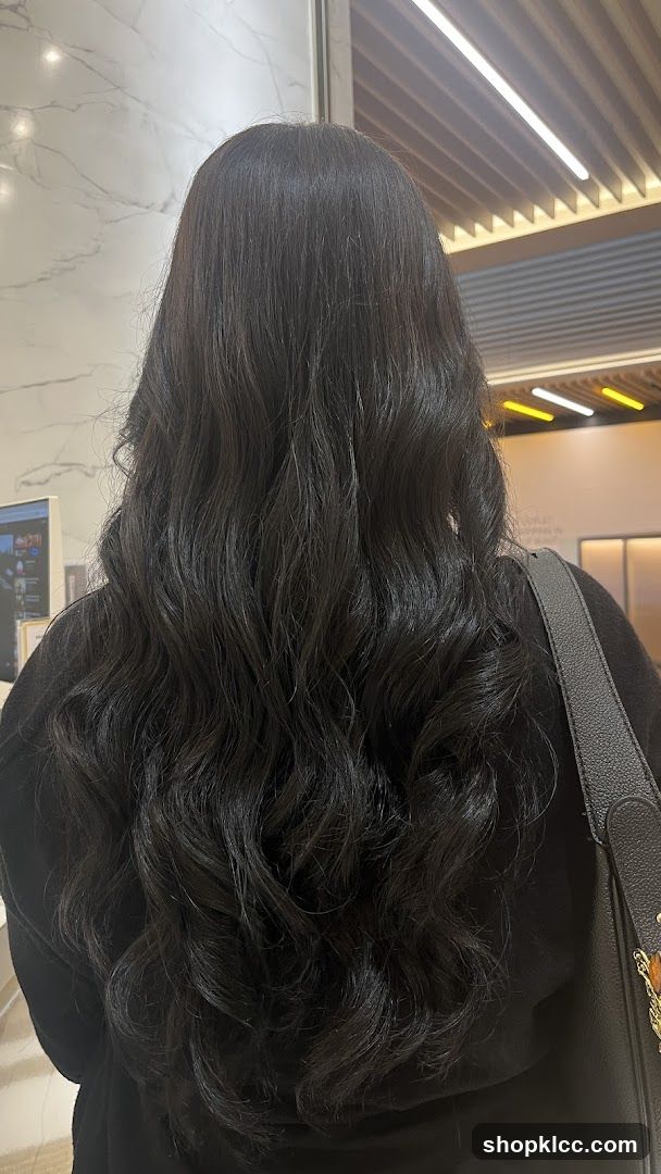 Woman with long, wavy dark hair