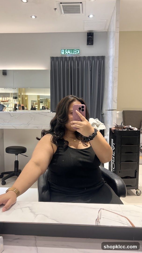 Woman taking a selfie in a salon