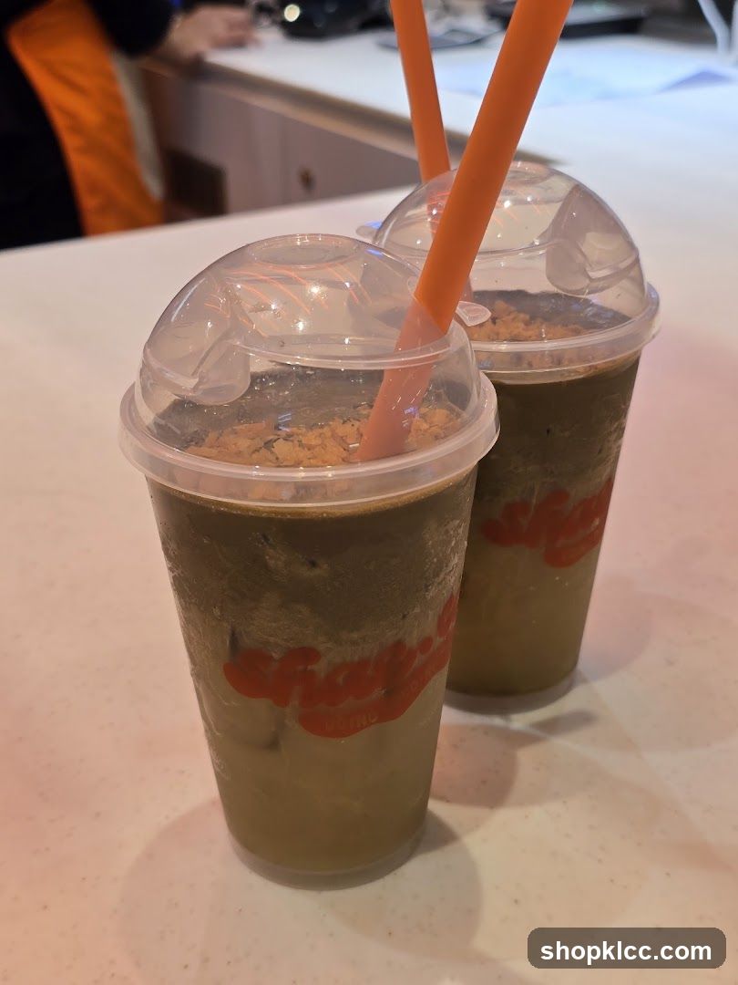 Two iced drinks with orange straws
