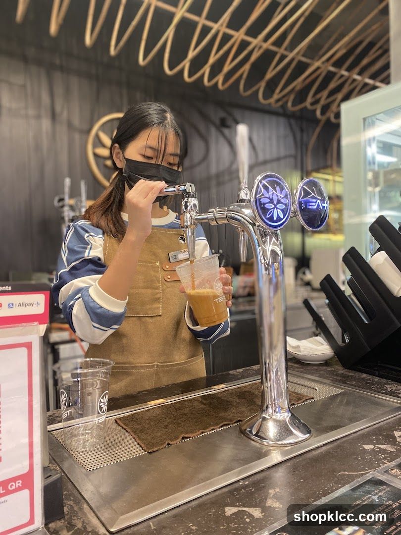 Barista pouring a drink