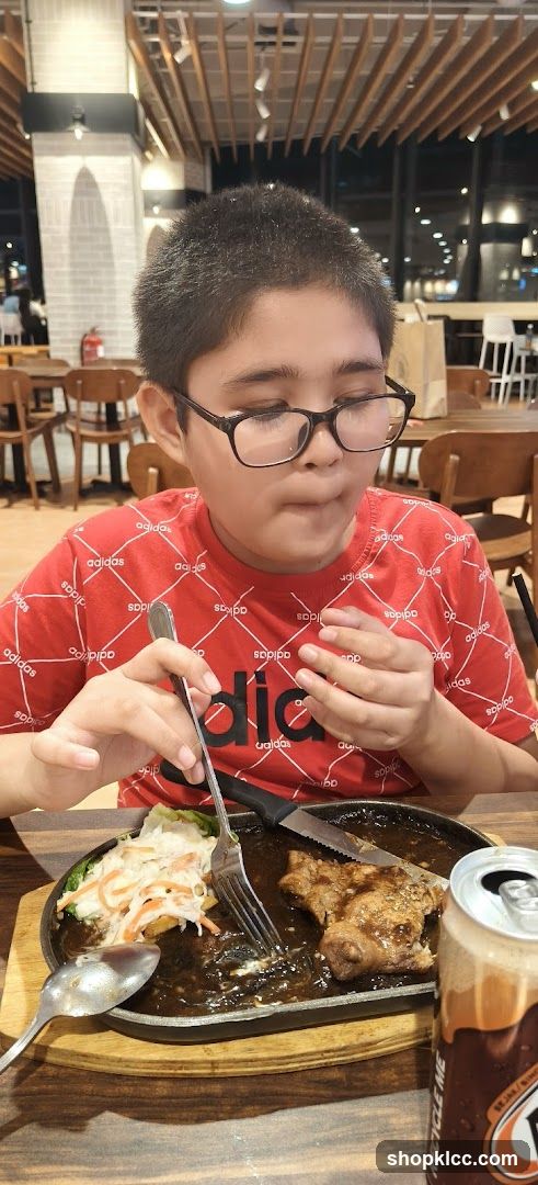 Boy eating steak