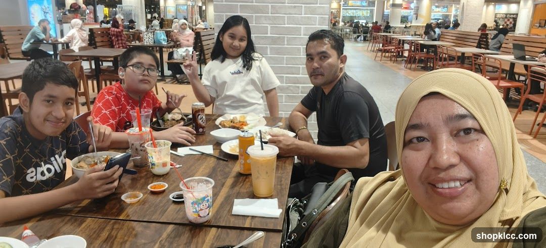 Family enjoying a meal at a food court