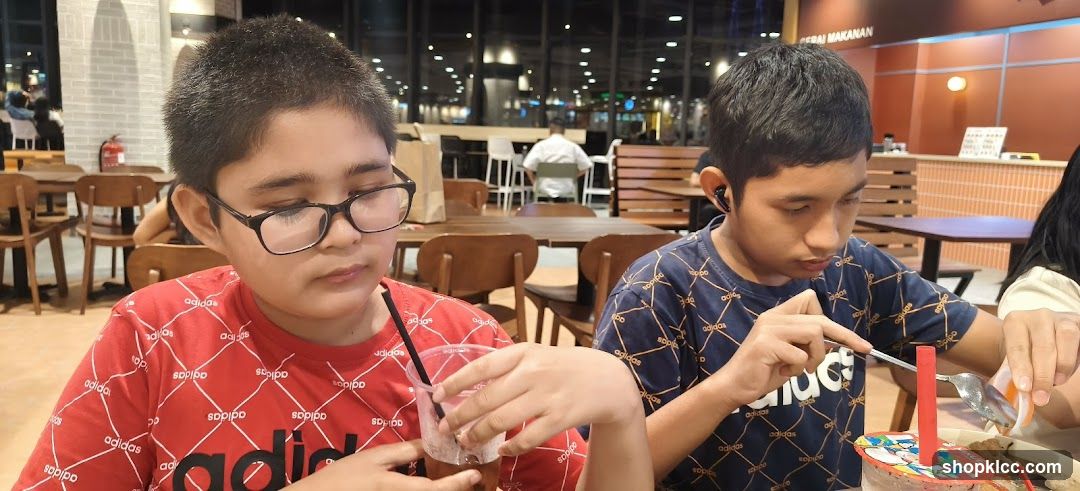 Two boys eating at a restaurant