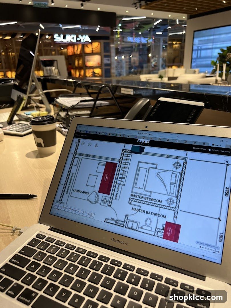Office desk with laptop displaying floor plan