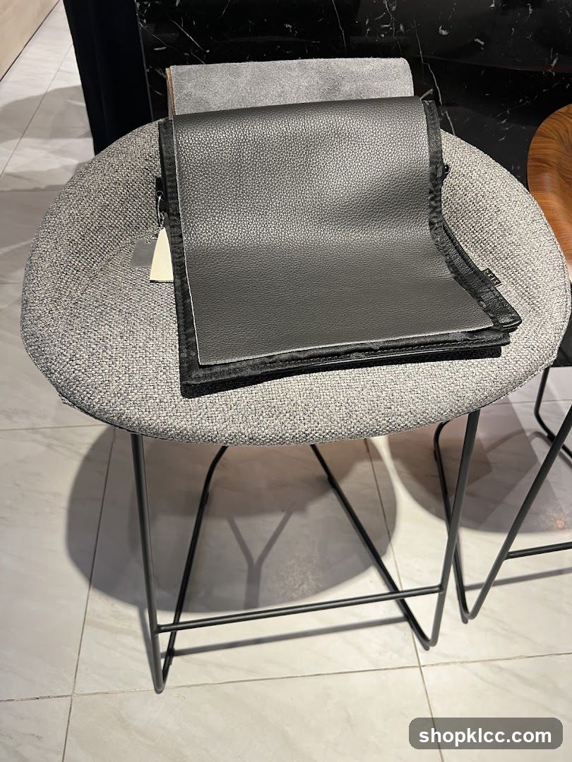 Folded Black Leather Item on Stool