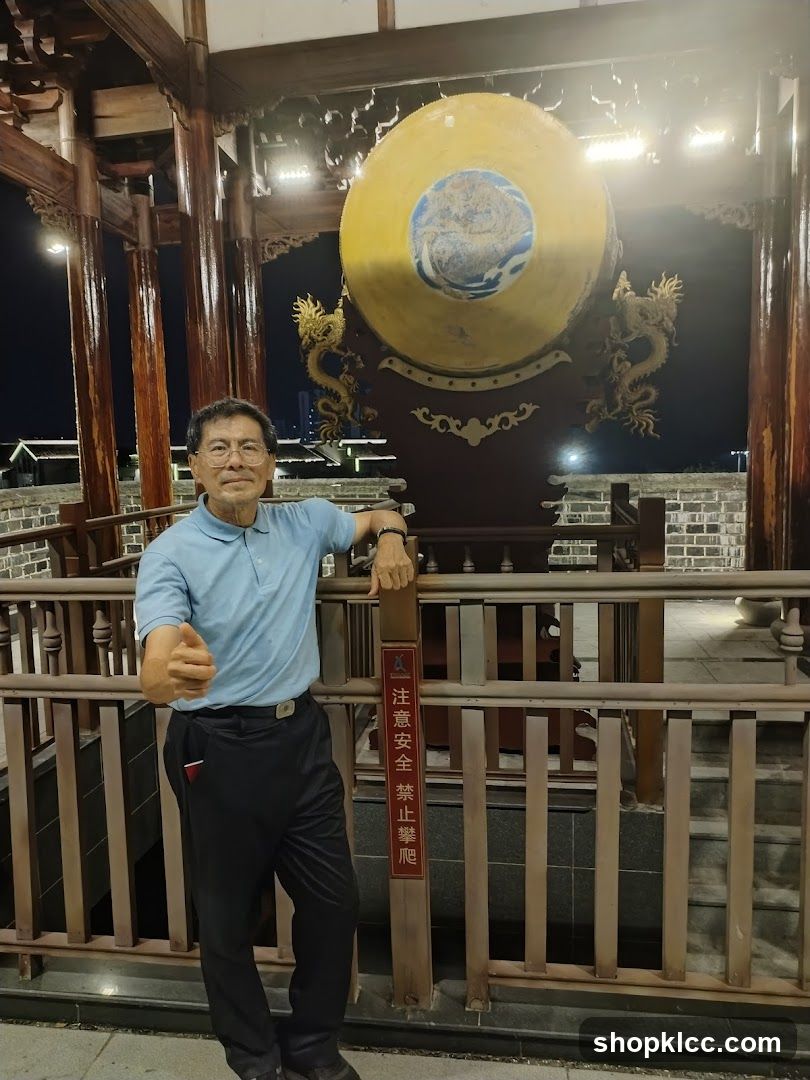 Man posing near a large drum at night