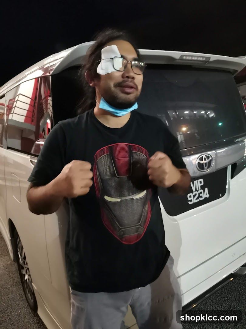 Man with eye patch and Iron Man shirt