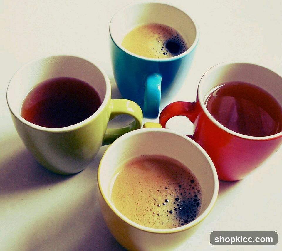 Four colorful mugs of coffee and tea