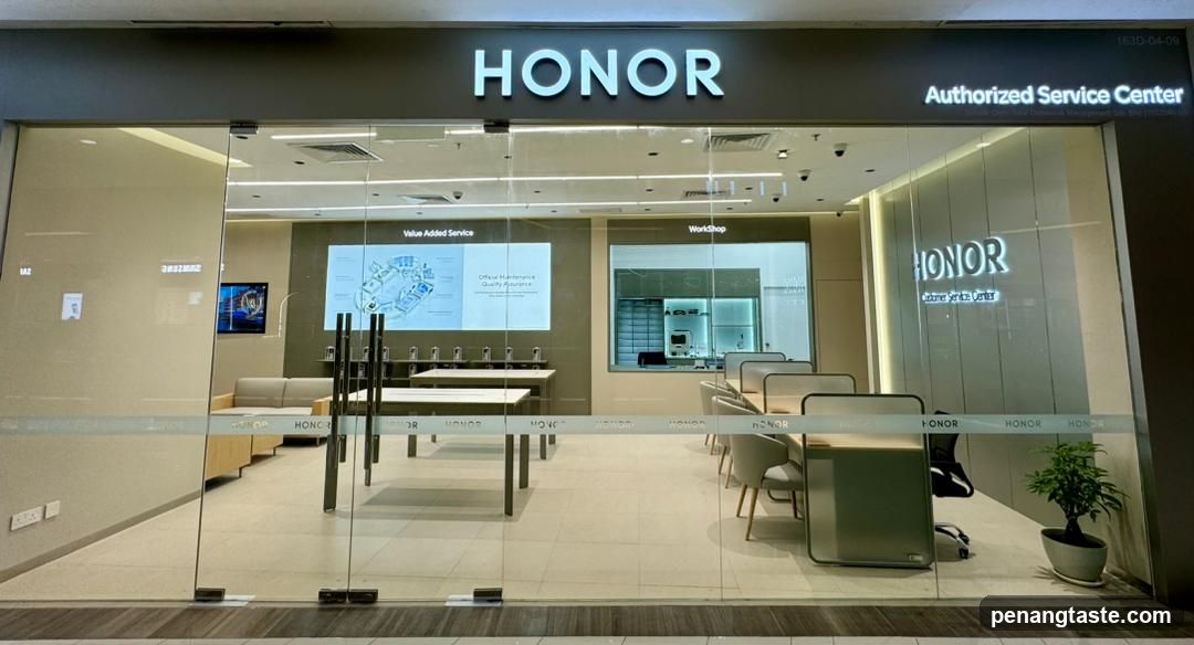 The exterior of an HONOR Authorized Service Center with large glass doors and windows. The HONOR logo is prominently displayed above the entrance. Inside, there are seating areas, tables, and a workshop area visible. The words "Value Added Service" and "Workshop" are displayed on screens within the store.