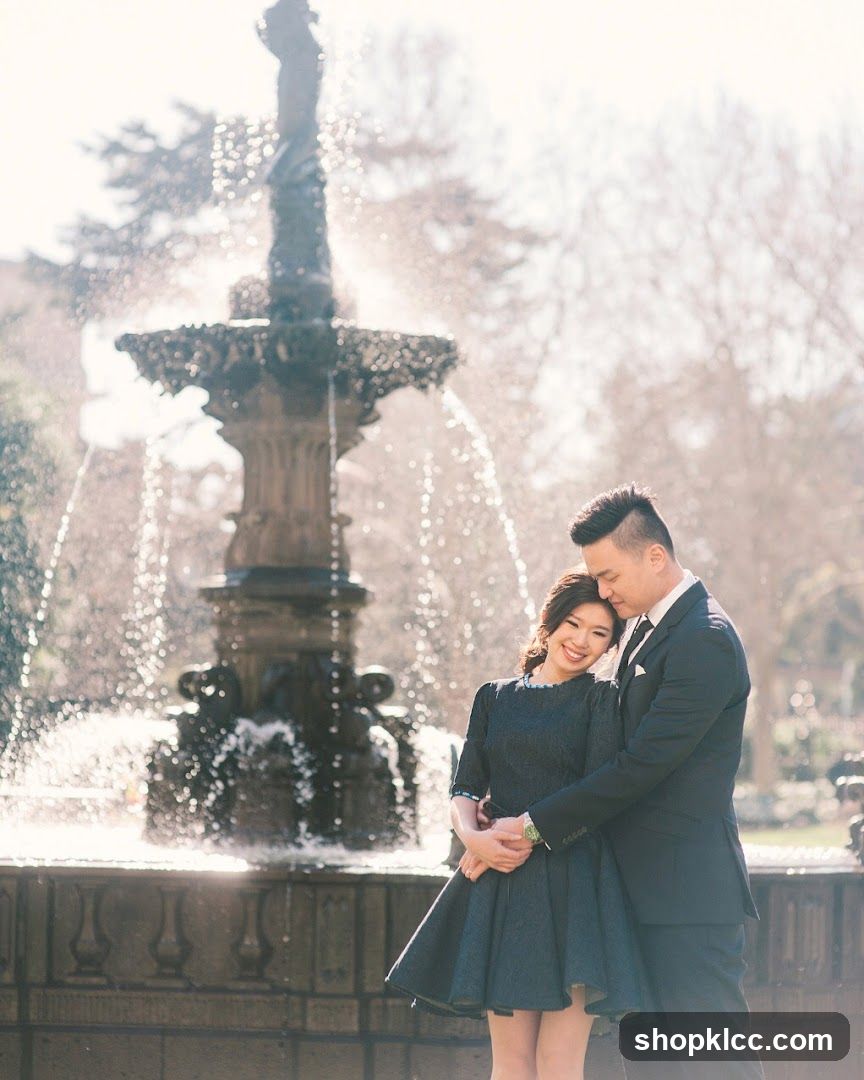 Couple posing in front of a fountain