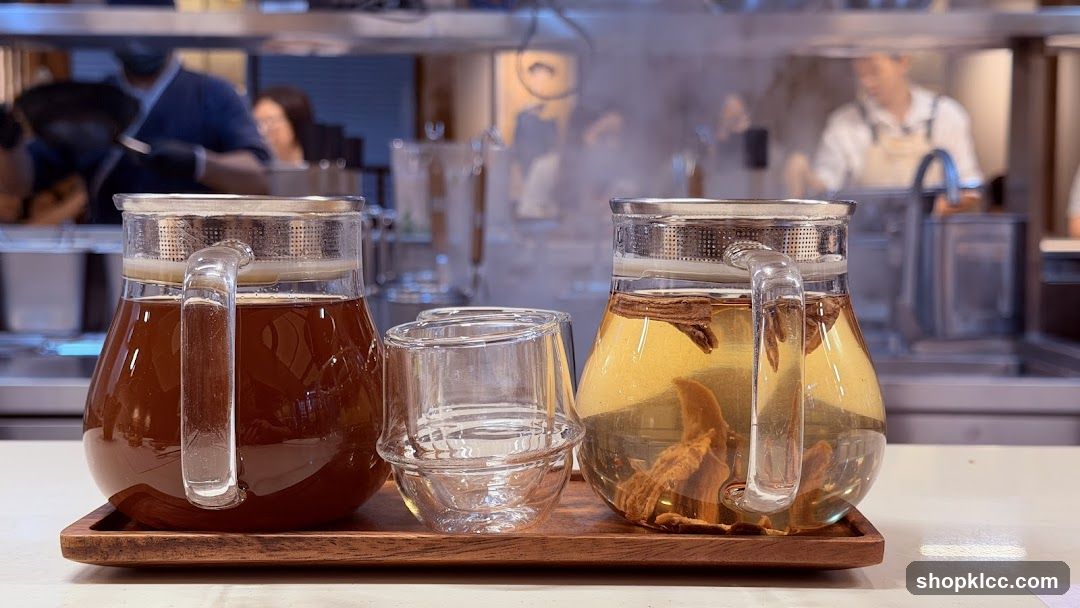 Two pitchers of tea and a glass