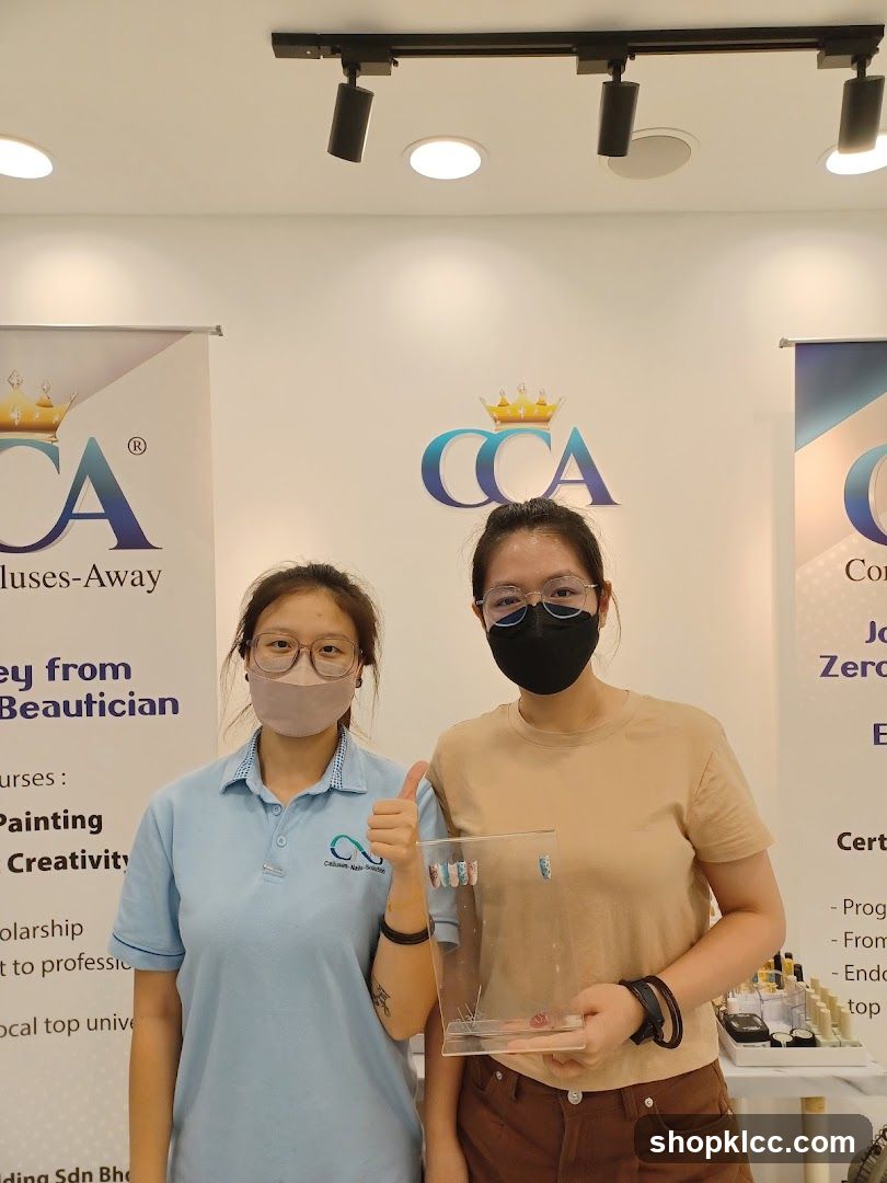 Two women posing with nail art samples