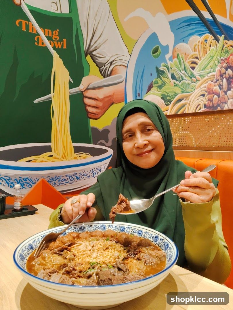 Woman Eating Beef Noodle Soup
