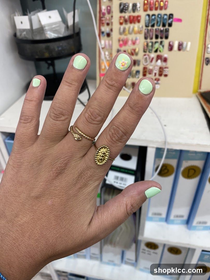 Light Green Nails with Flower Accent