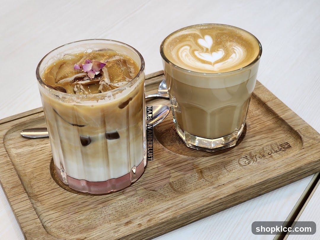 Two coffee drinks on a wooden tray