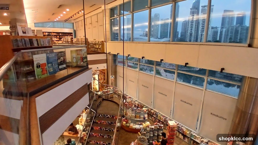 Interior of a multi-level bookstore with a view of city skyscrapers