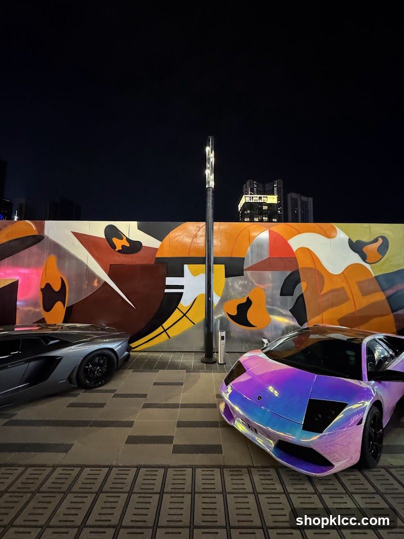 Luxury Cars Parked by Mural