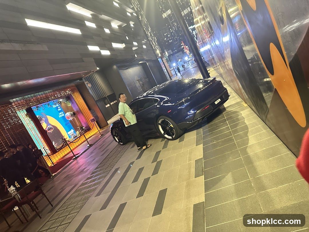 Man Poses Next to a Car