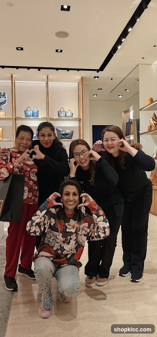 Group of women making heart shapes with their hands
