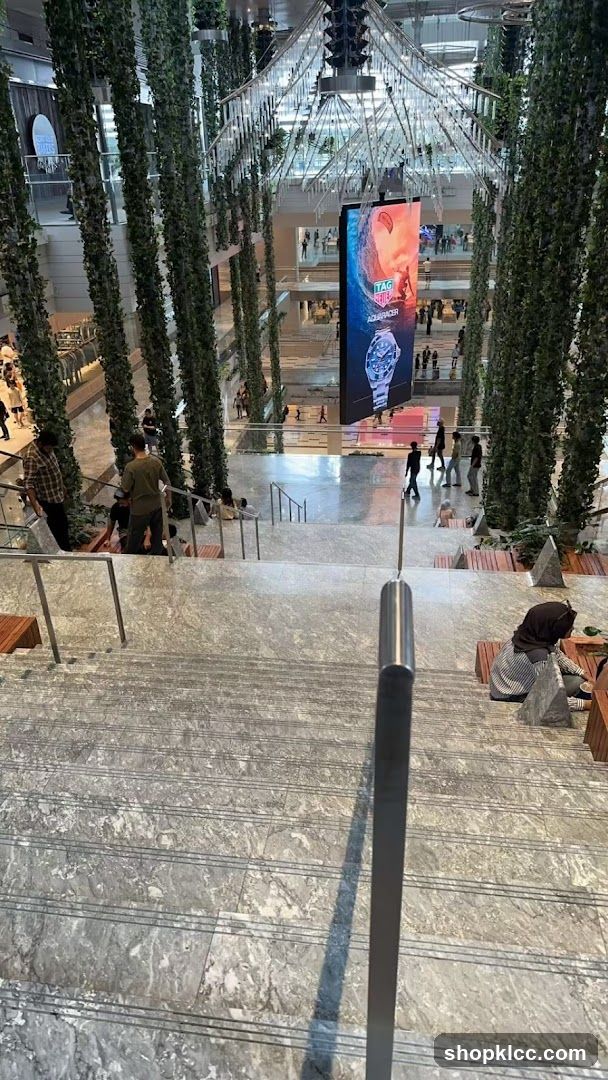 Indoor mall with greenery and digital advertisement