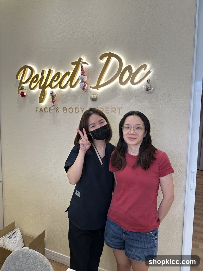 Two Women Posing in Front of a Sign