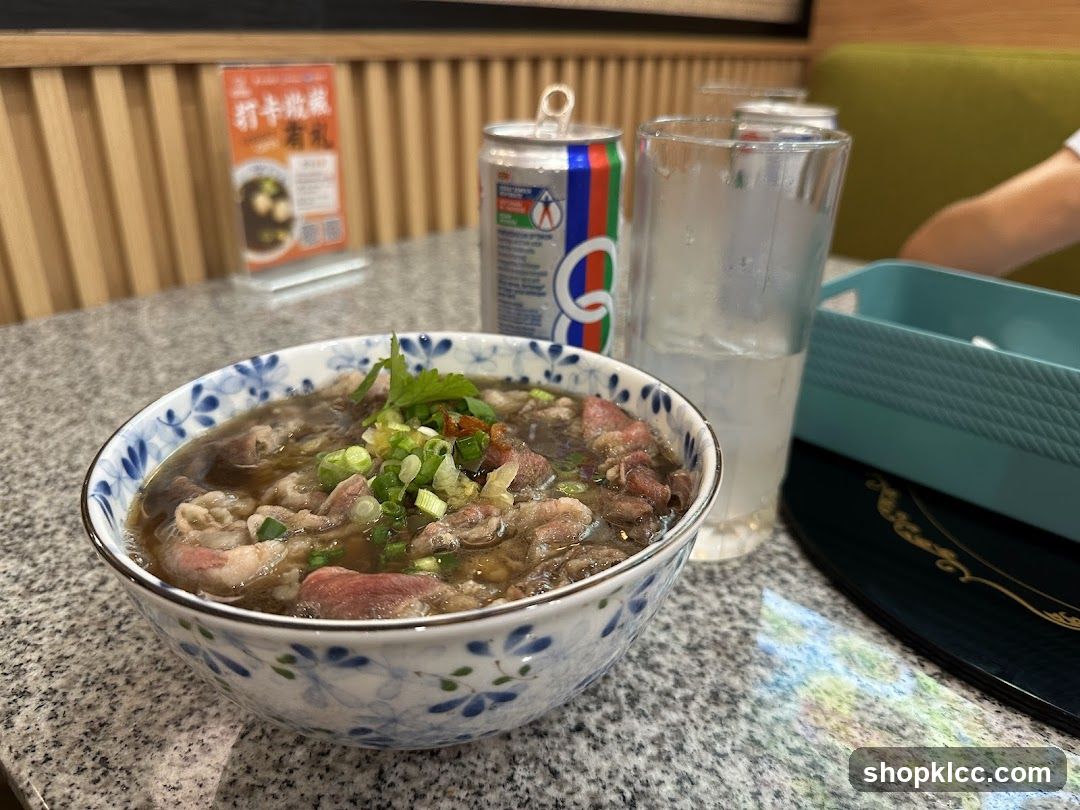 Beef noodle soup with a can of soda