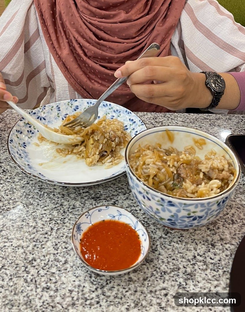 Person eating rice dish