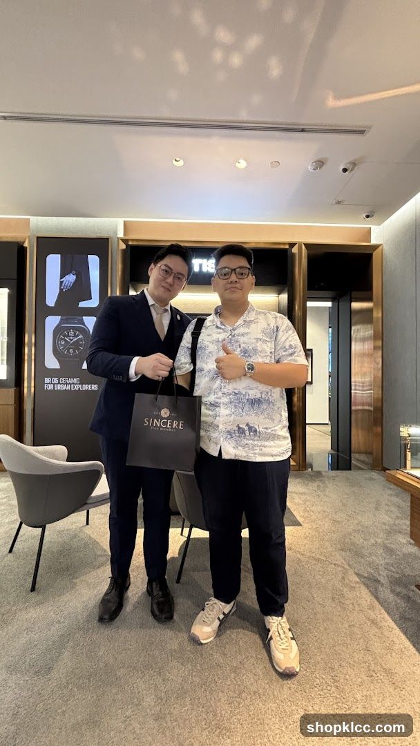Two men posing in a watch store
