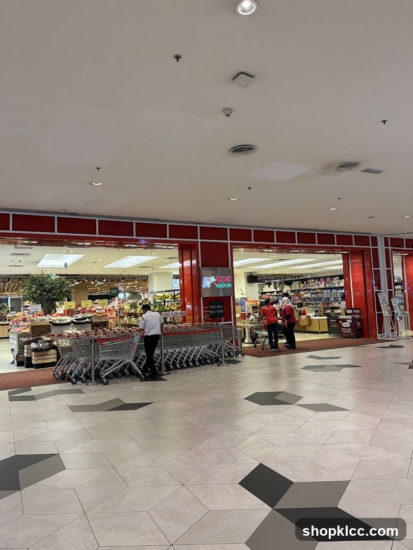 The exterior of a Tiong Bahru Grocer supermarket. Shopping carts are lined up outside the entrance. Inside, shelves are stocked with various products.