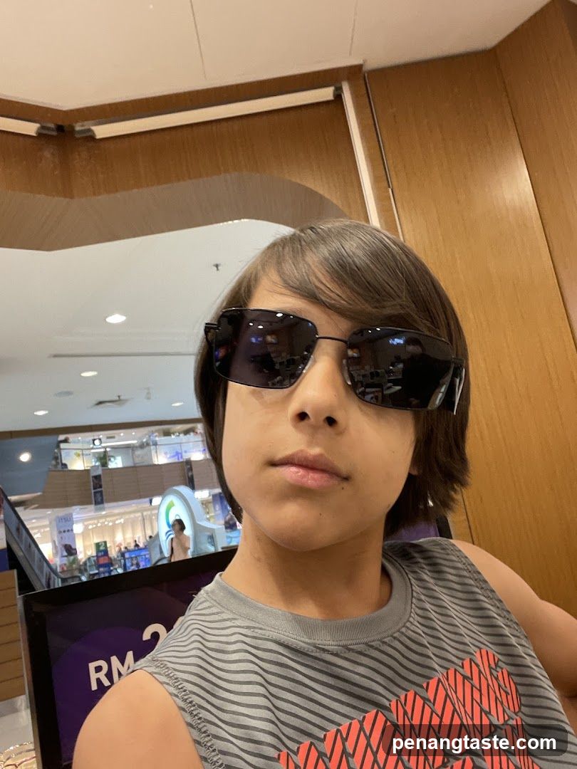 Boy trying on sunglasses