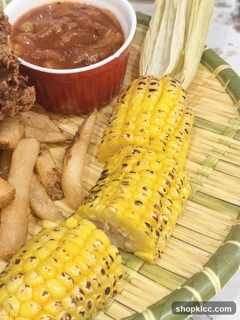 Corn on the cob with fries and sauce