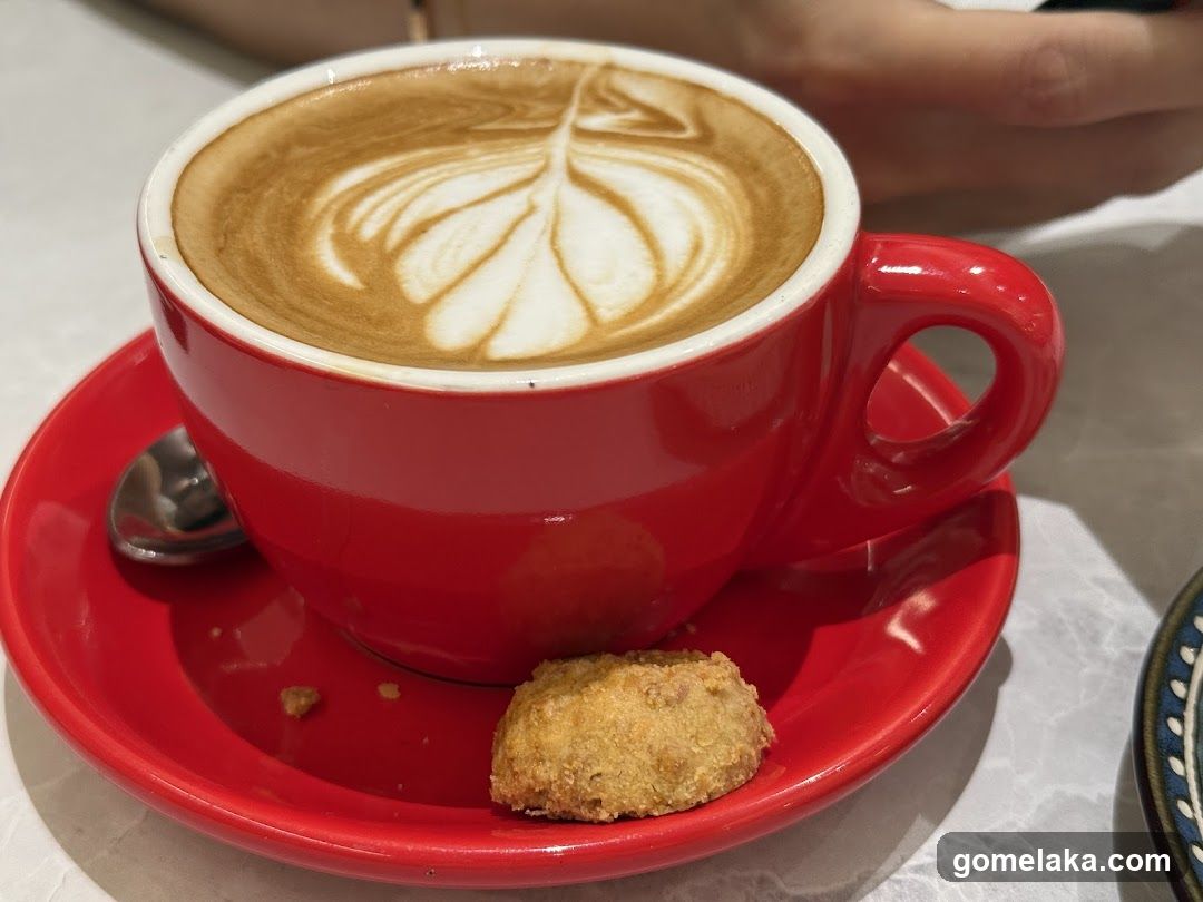 Coffee and Cookie on Red Saucer