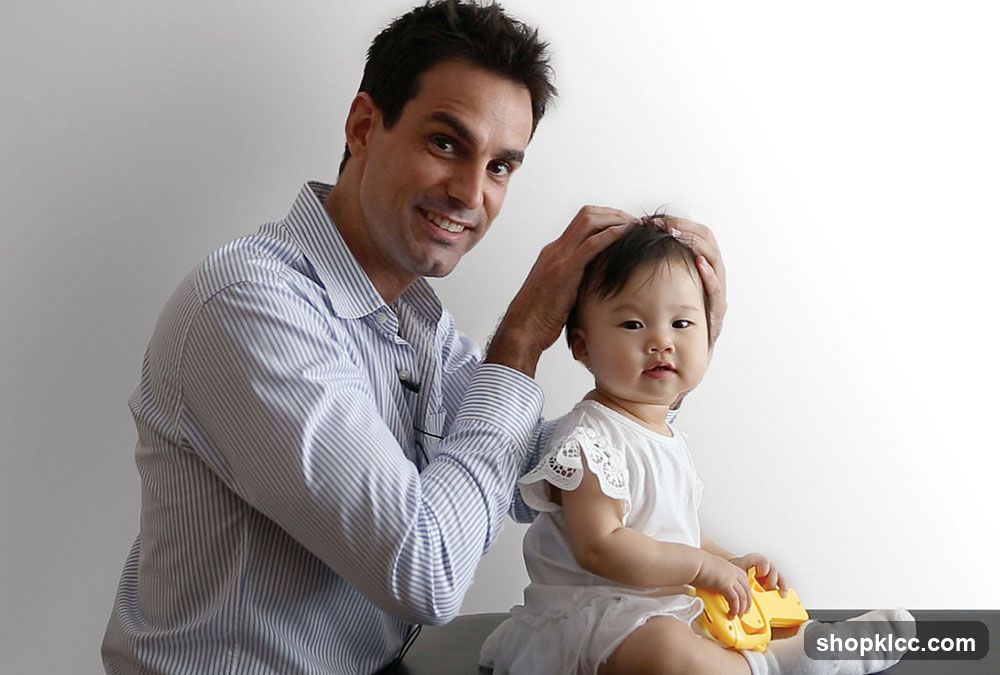 Man examining a baby's head