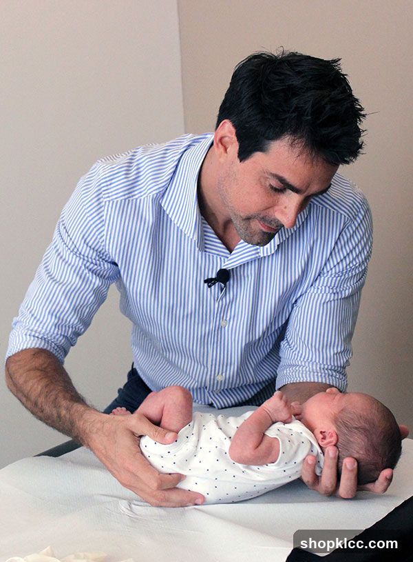 Chiropractor examining a baby