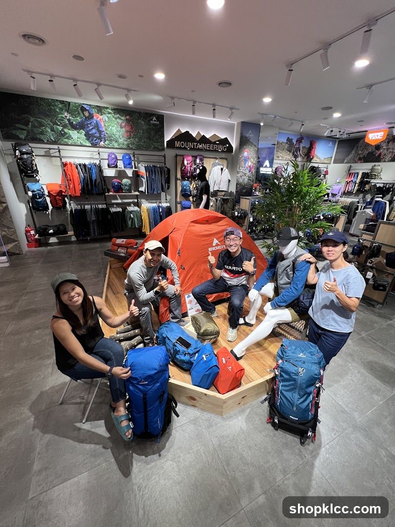 People posing with camping gear in a store