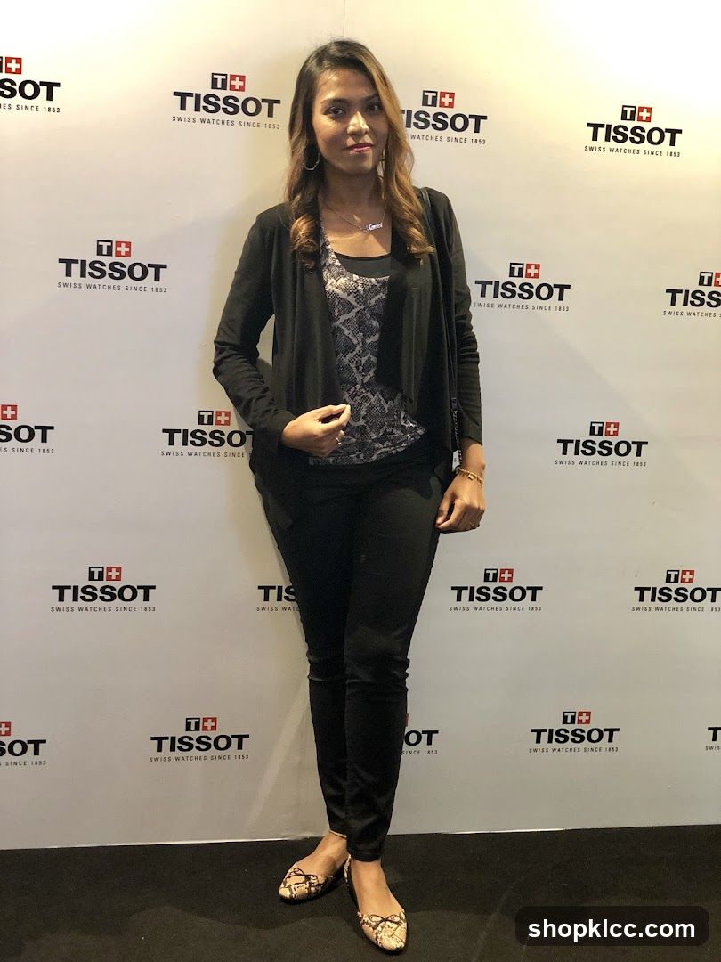 Woman Posing in front of Tissot Logo Wall