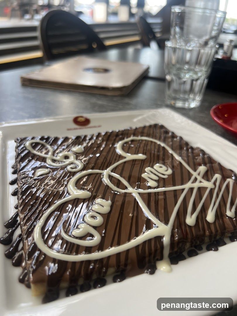 Chocolate Crepe with "Love Me" written in white icing
