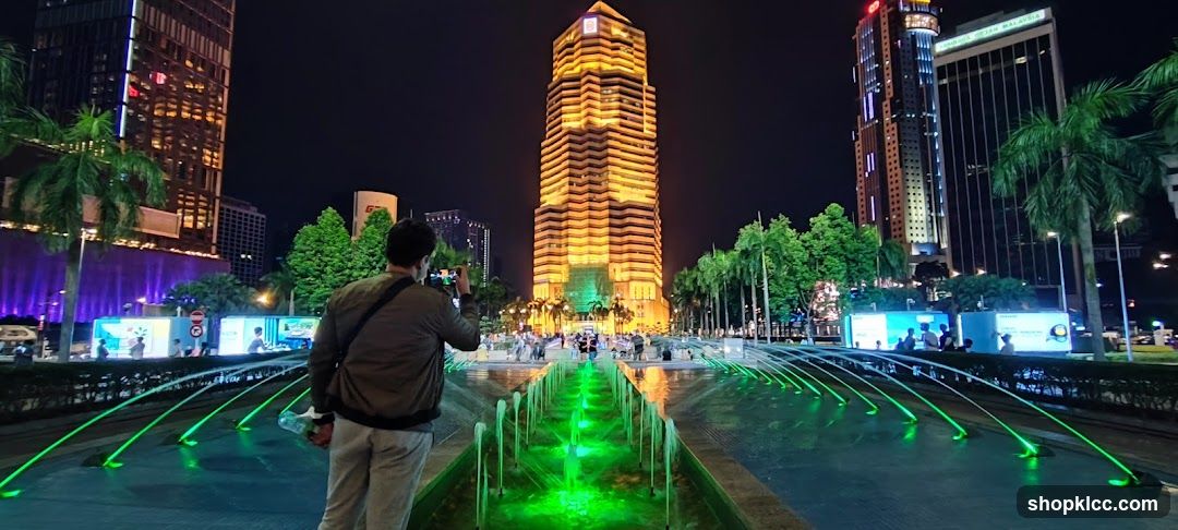 Nighttime cityscape with illuminated fountain