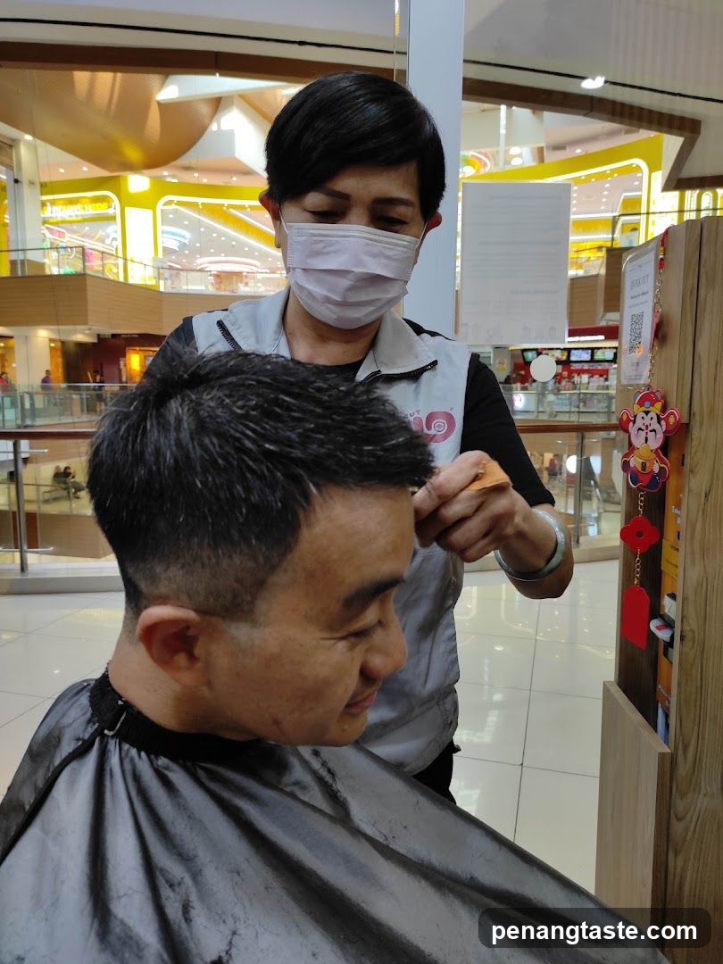 Hairdresser giving a haircut