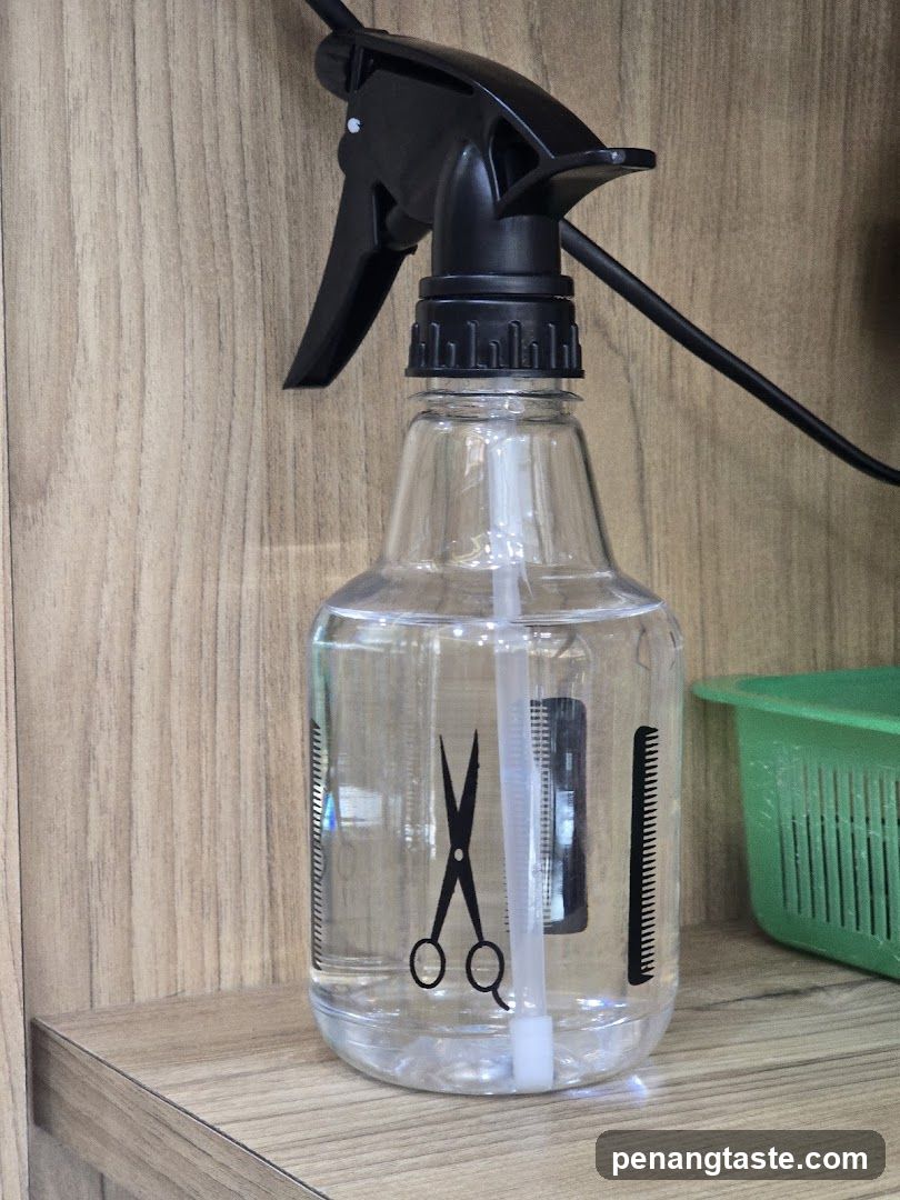 Spray bottle with scissors and comb graphic