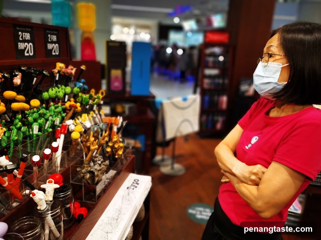 Woman in a store looking at novelty pens