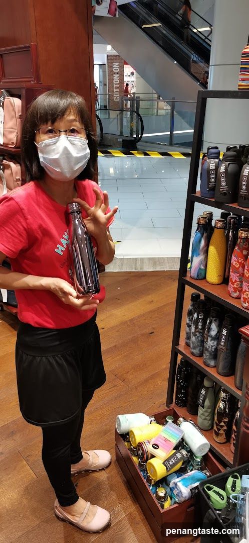 Woman holding a water bottle in a store