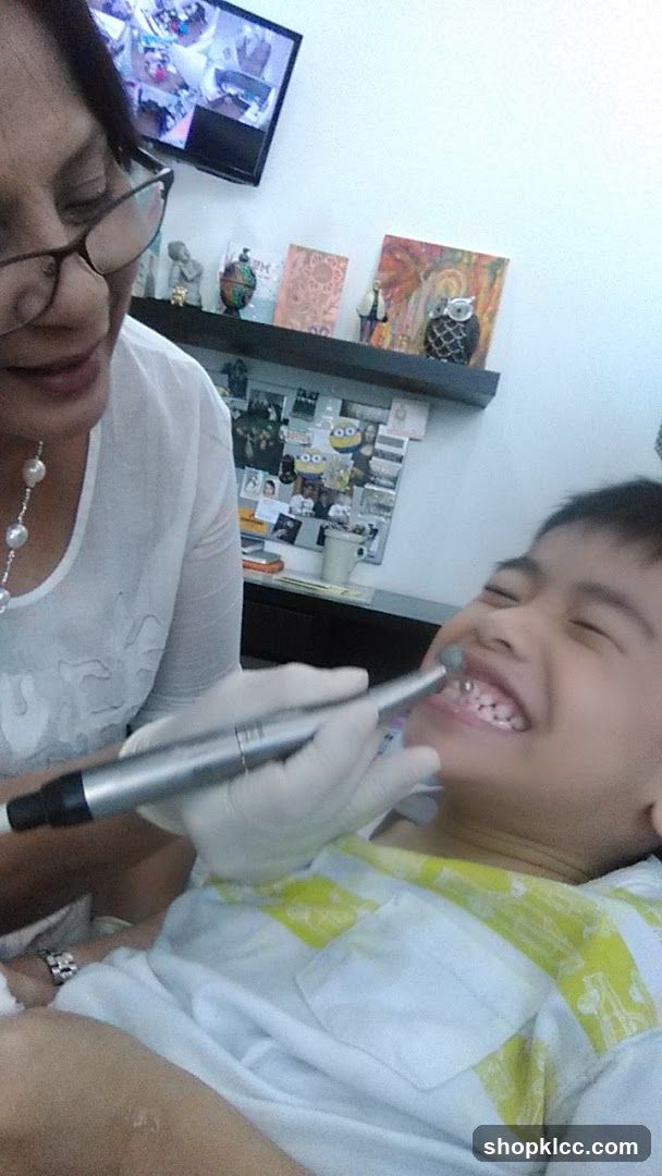 Dentist cleaning a child's teeth
