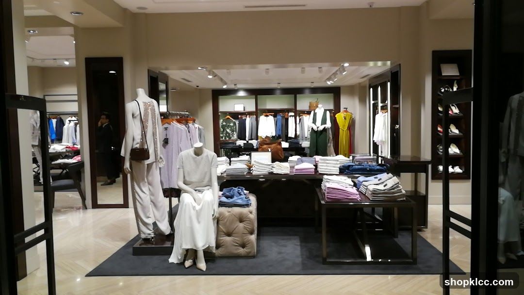Clothing store interior with mannequins and folded apparel