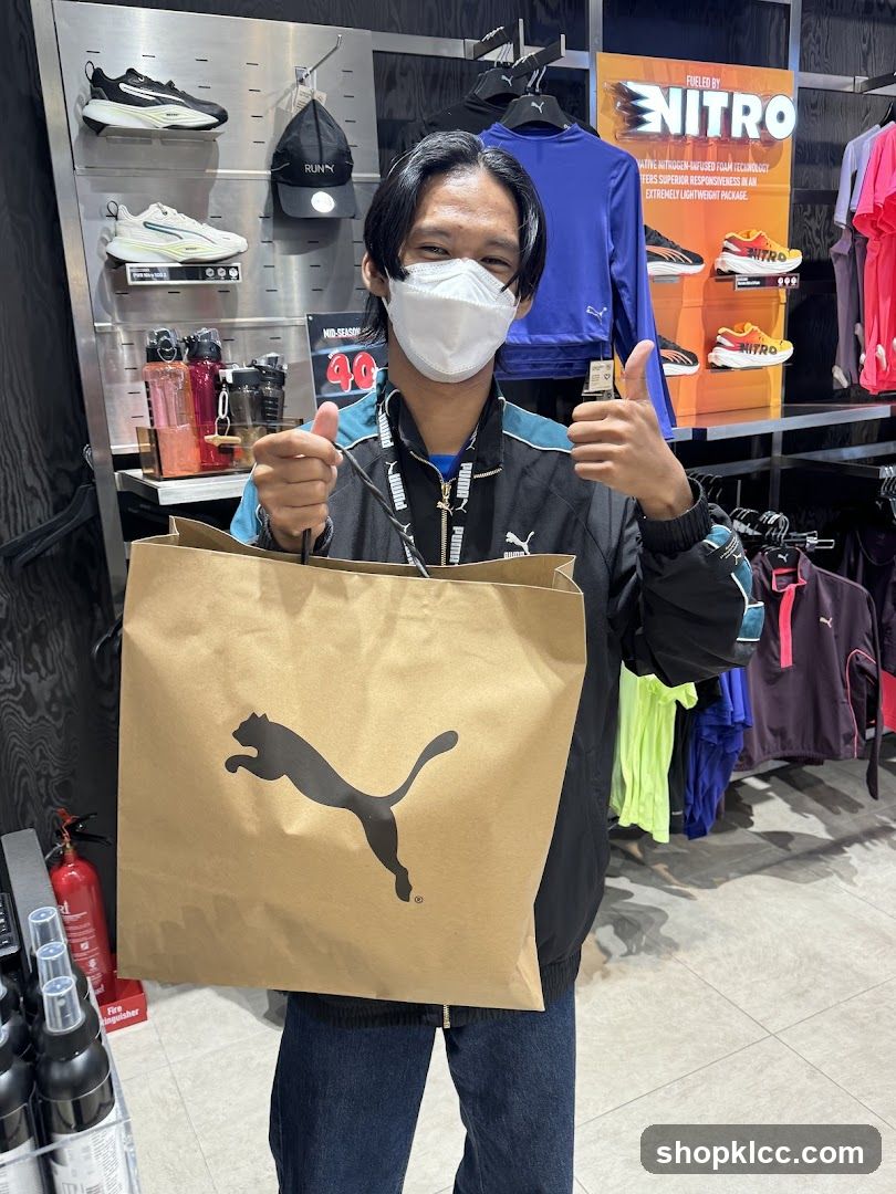 Man holding a Puma shopping bag