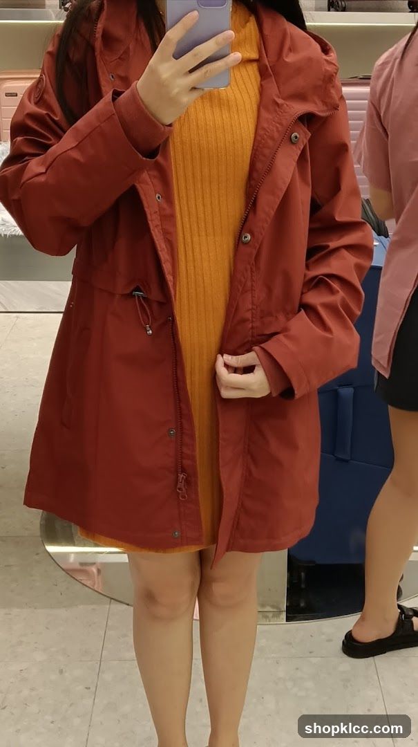 Woman in Orange Dress and Red Jacket