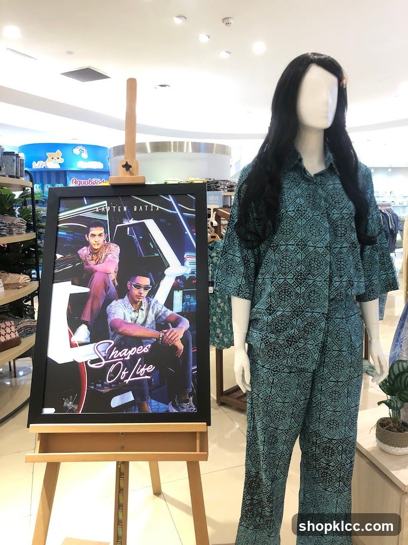 Mannequin wearing batik clothing with promotional poster