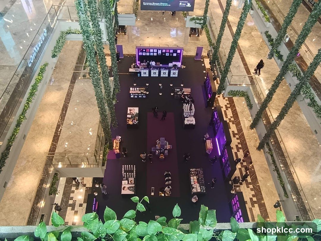 Indoor shopping mall with greenery and pop-up stalls