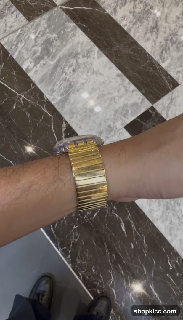 Gold watch on wrist